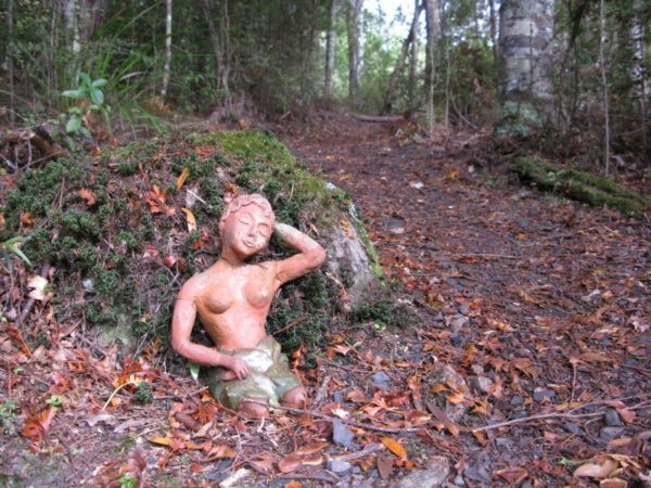 A goddess statue on the path through the woods