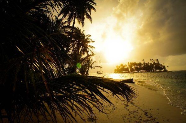sun sets over island